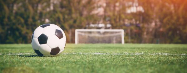 football on pitch with net in bg